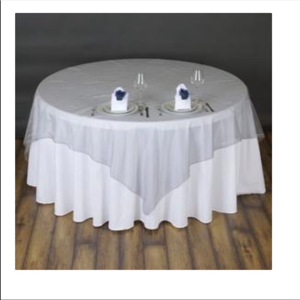 White round table cloth and silver overlays